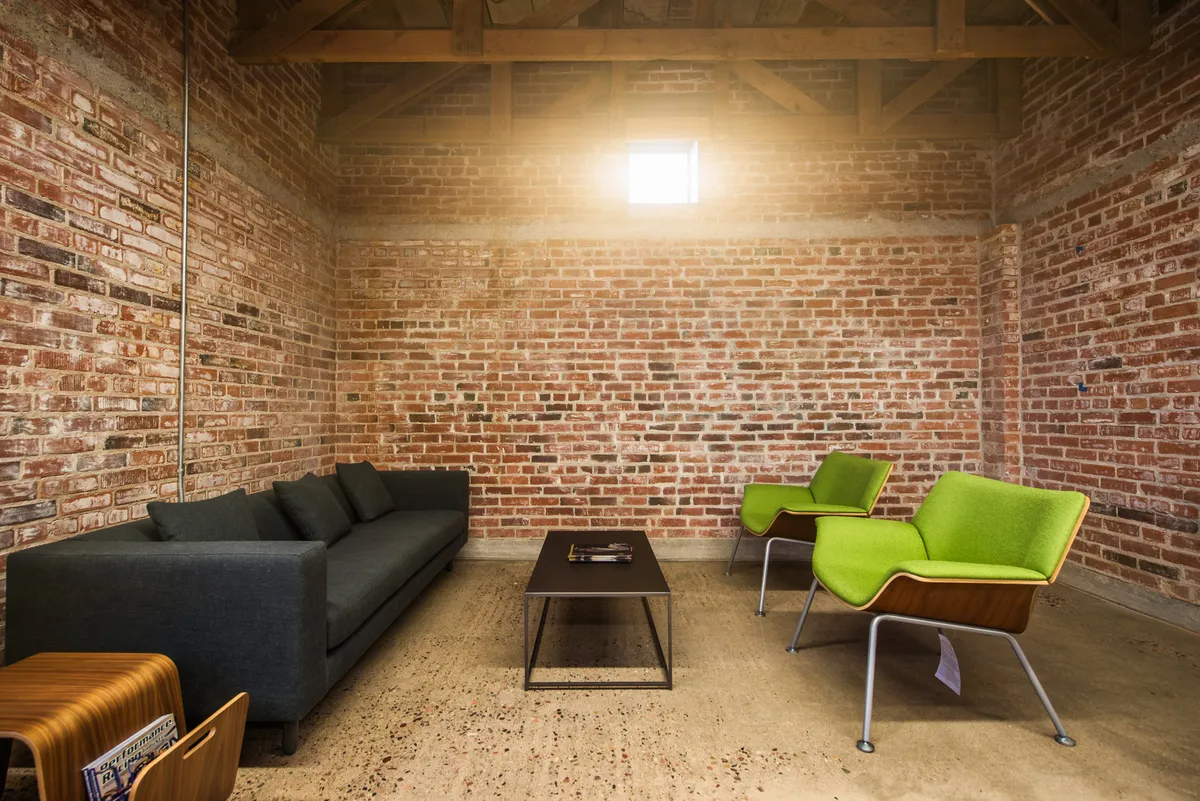Autoline lounge and meeting space with exposed brick